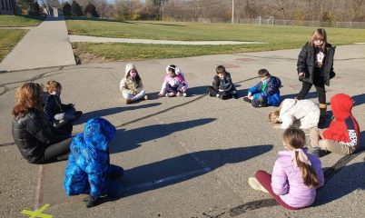kids playing duck duck goose