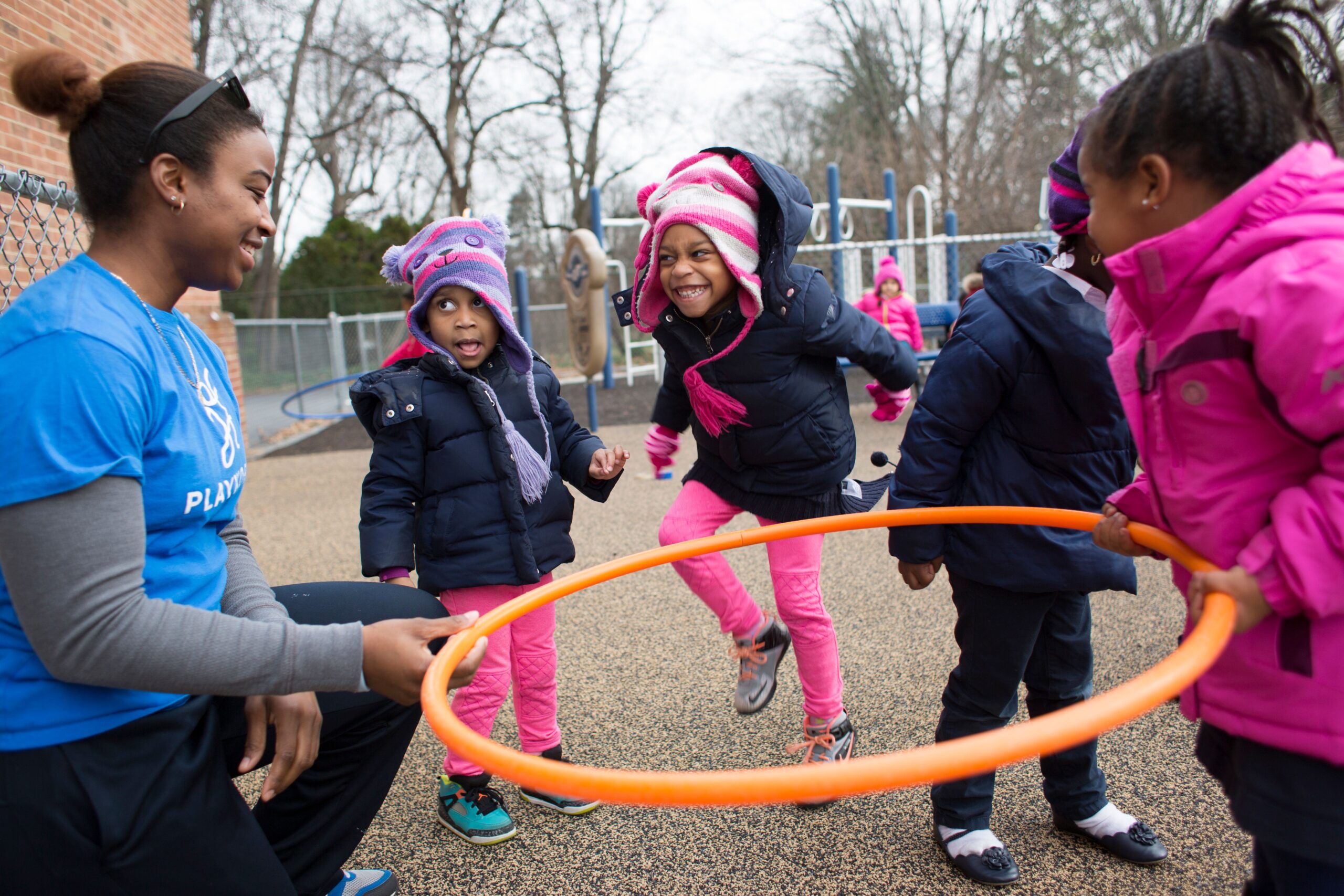 Coach with kids and hula hoop