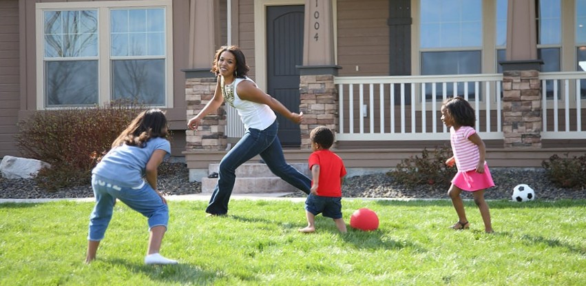 parent playing with kids outside