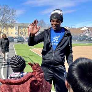 Coach Q giving a student a high-five