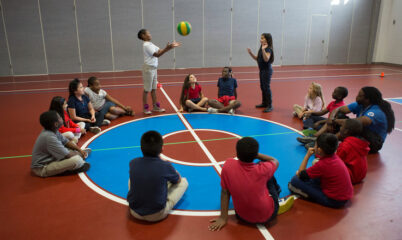 students in circle playing game with ball