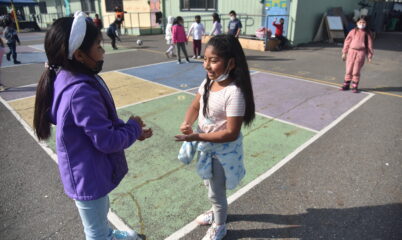 two girls playing on blacktop