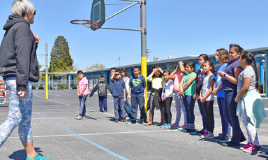 coach leading kids in game