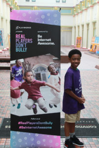 Junior coach next to pop up banner