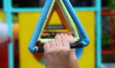 hands hanging from monkey bars