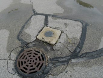 sewer cap and uneven cement