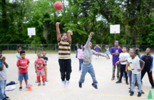 Child shooting a ball on a playground