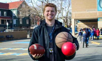 Coach on blacktop with play equipment