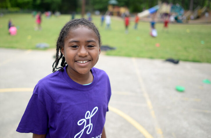 Junior Coach smiling on playground