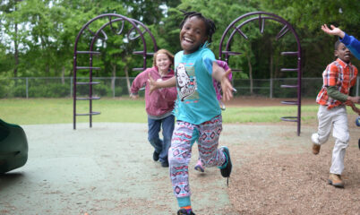 kids running and smiling on playground