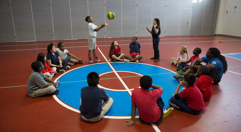 students in circle playing game with ball