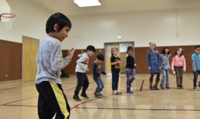 kids standing in circle in gymnasium