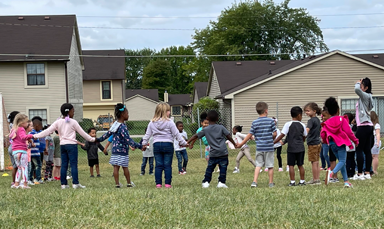 children holding hands in circle