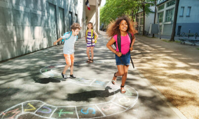 Group of kids jumping and playing hopscotch