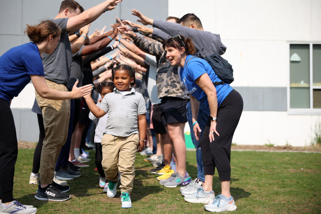 adults greeting students at recess