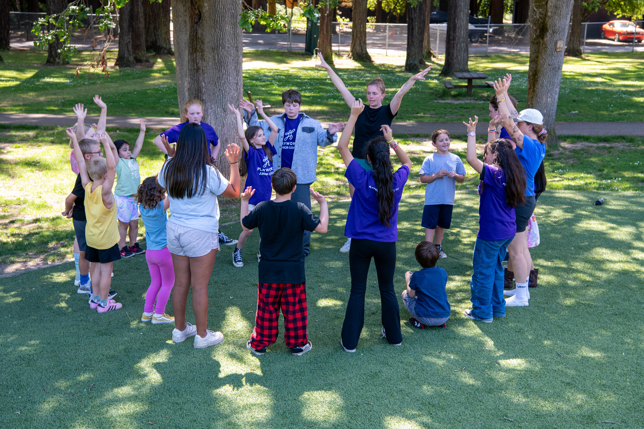 kids in circle with arms up