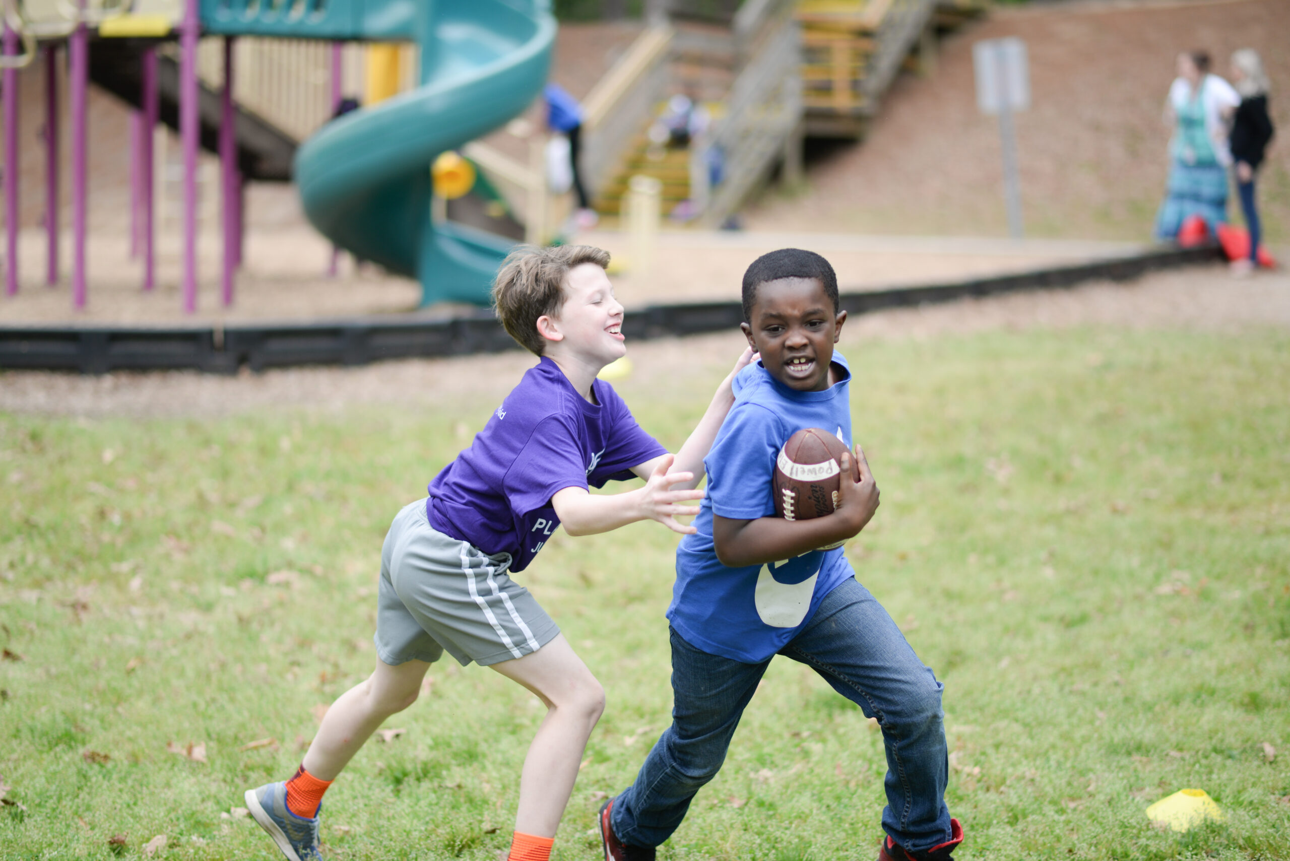 two kids playing football